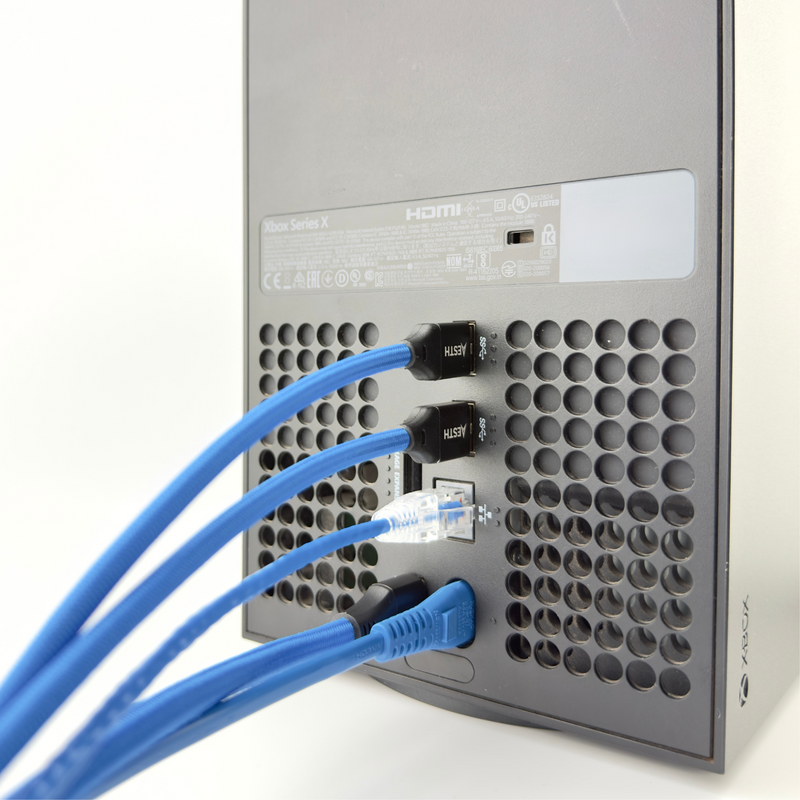 Xbox with blue braided cables
